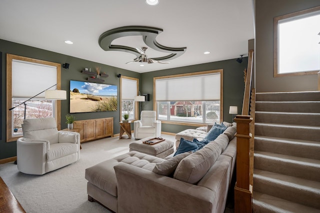 carpeted living room with ceiling fan