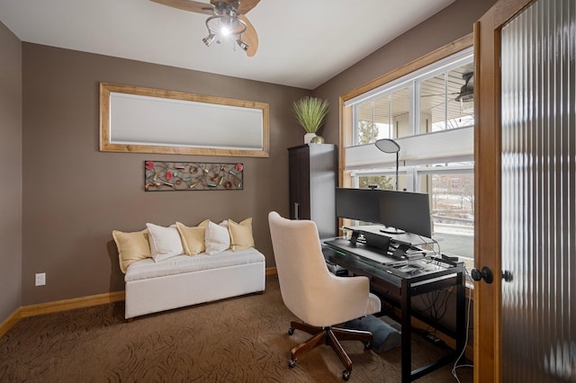 carpeted office featuring ceiling fan