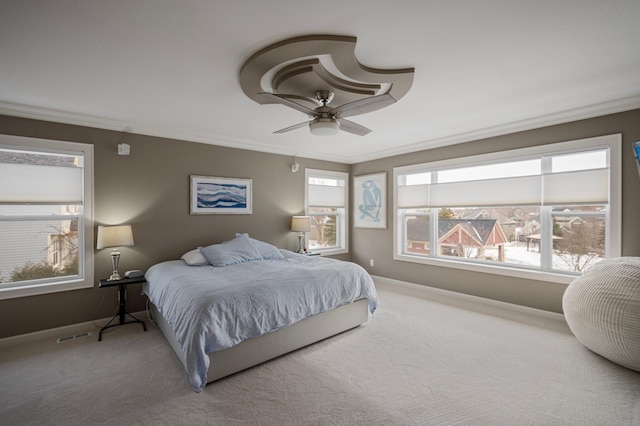 carpeted bedroom with crown molding and ceiling fan