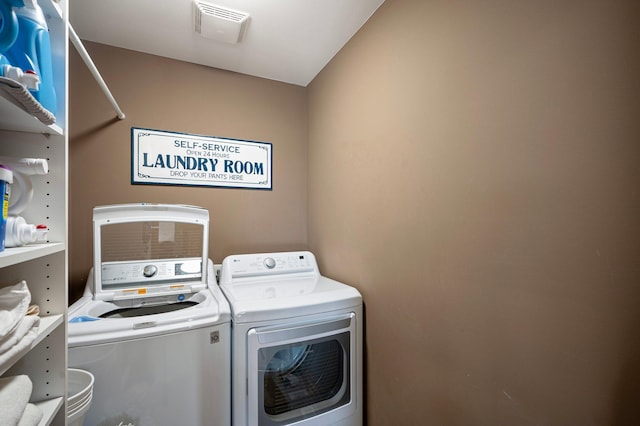 clothes washing area with washer and clothes dryer