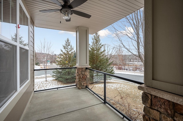 snow covered patio featuring ceiling fan