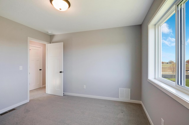 carpeted spare room with plenty of natural light