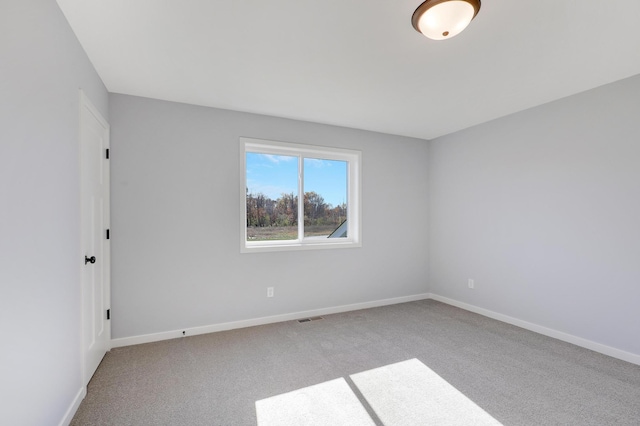 unfurnished room with light carpet