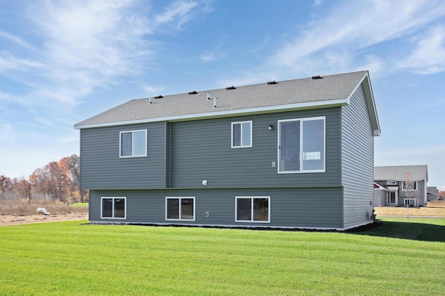 rear view of house with a yard