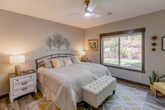 bedroom with ceiling fan and wood-type flooring