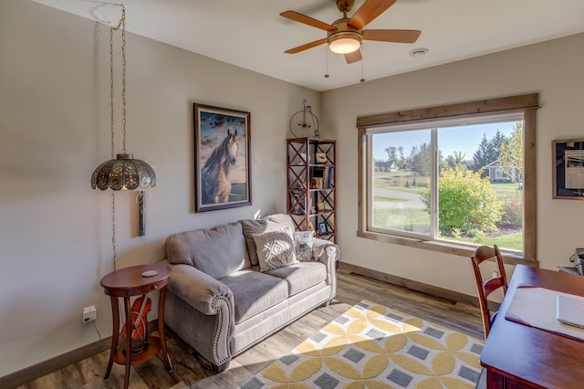 living room featuring hardwood / wood-style floors and ceiling fan