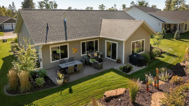 rear view of house with a lawn and a patio