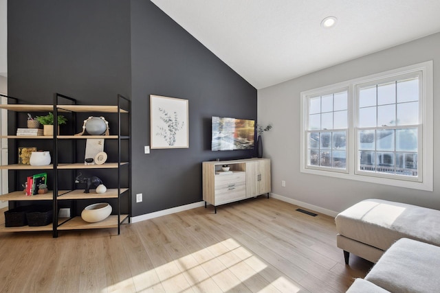 sitting room featuring light hardwood / wood-style flooring and vaulted ceiling