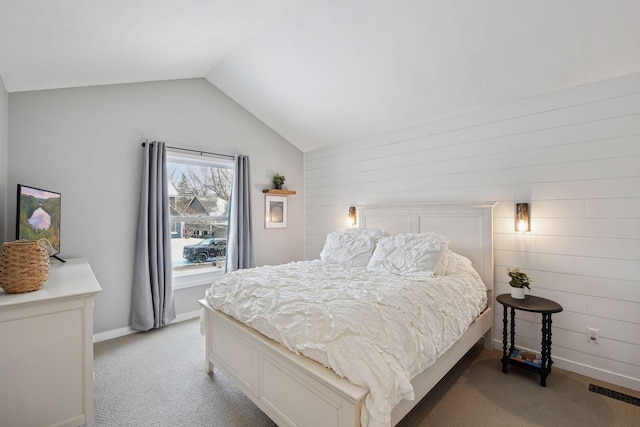 carpeted bedroom with lofted ceiling