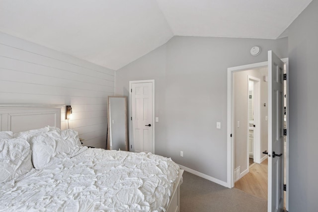 carpeted bedroom featuring lofted ceiling