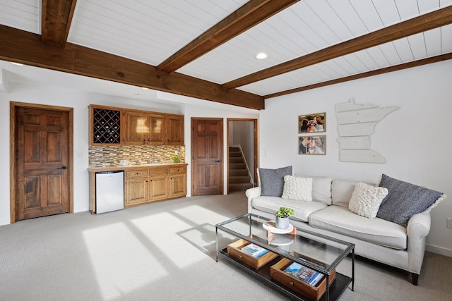 living room with beamed ceiling, indoor bar, and light carpet