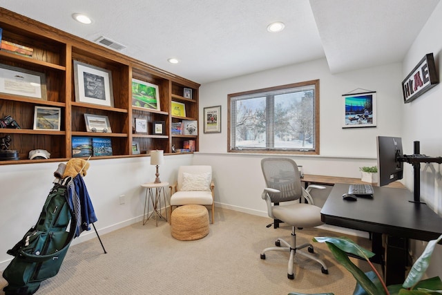 carpeted home office with a textured ceiling