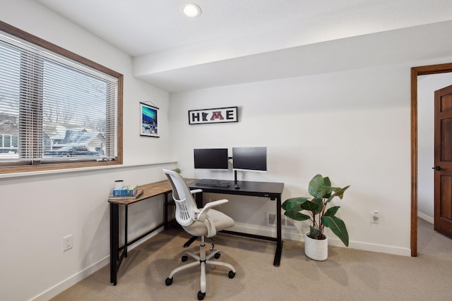 office area featuring light colored carpet