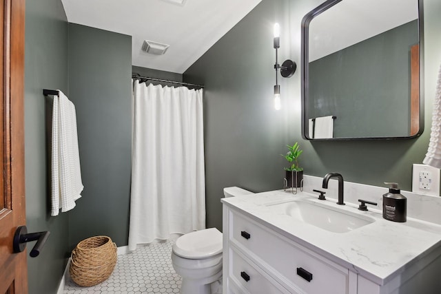 bathroom with vanity, tile patterned flooring, and toilet