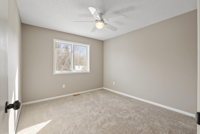 spare room with ceiling fan, carpet floors, and a textured ceiling