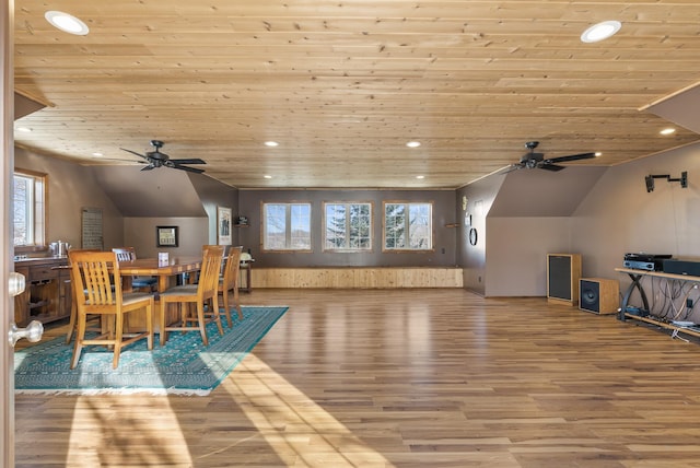 dining space with vaulted ceiling, a healthy amount of sunlight, and light wood-type flooring