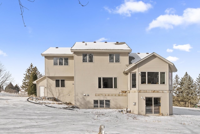 view of snow covered rear of property