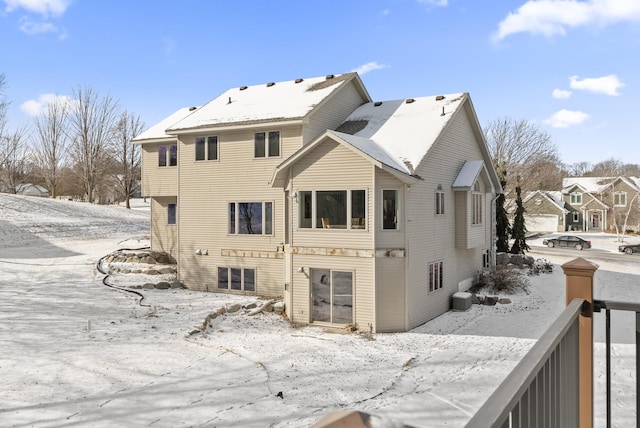 snow covered property featuring central AC unit