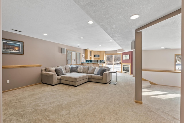 carpeted living room with a textured ceiling