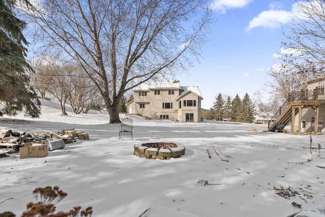 yard covered in snow featuring a fire pit