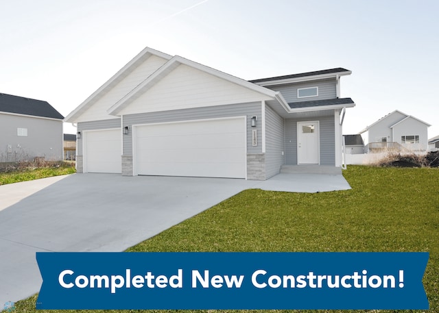 view of front facade with a garage and a front lawn