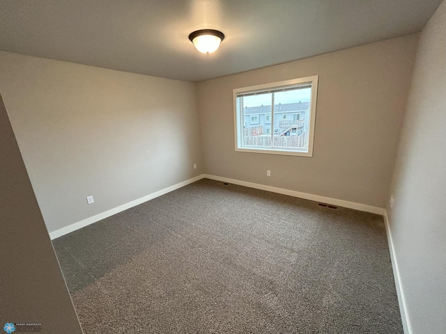 unfurnished room featuring carpet