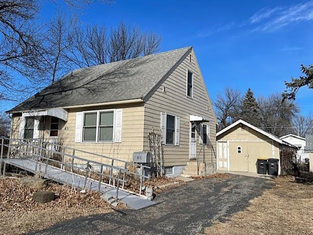 view of home's exterior with a shingled roof and fence