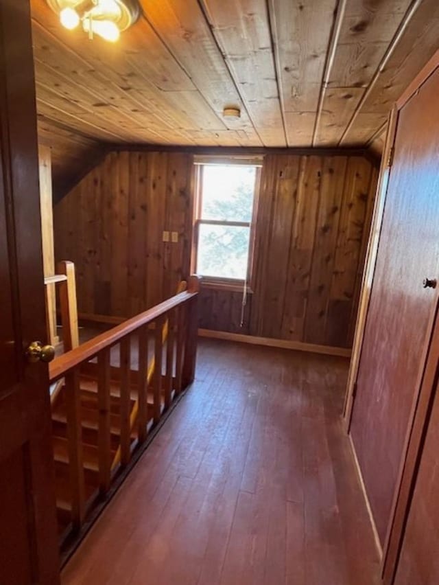 bonus room with hardwood / wood-style flooring, wood ceiling, and wood walls