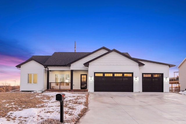 modern farmhouse featuring a garage and a porch