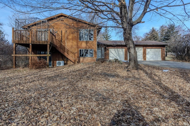 view of front of home featuring a garage and a wooden deck