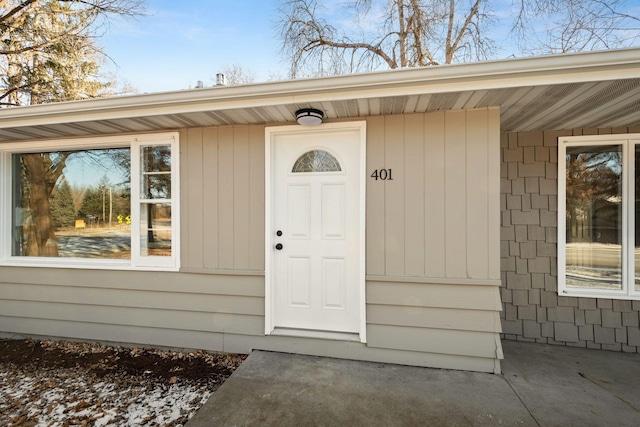 view of exterior entry with a patio area