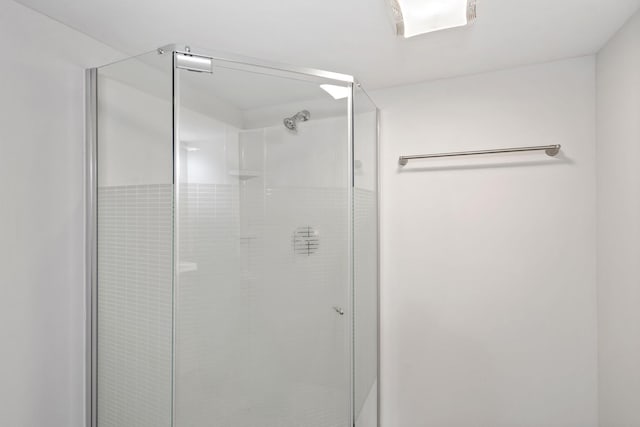 bathroom with a shower with shower door