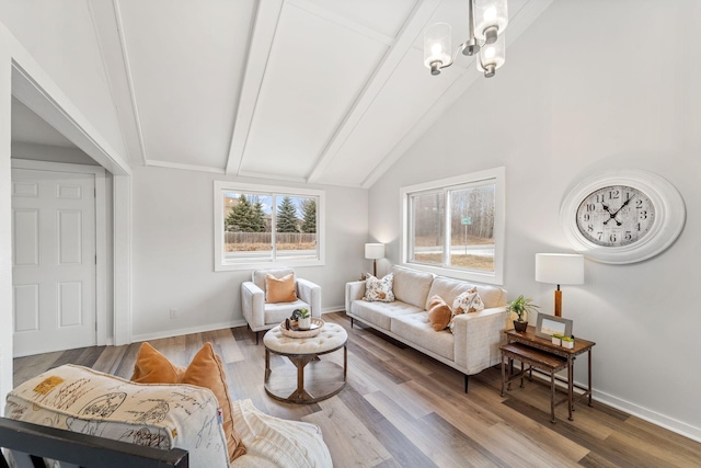 living room featuring vaulted ceiling with beams, hardwood / wood-style floors, and an inviting chandelier