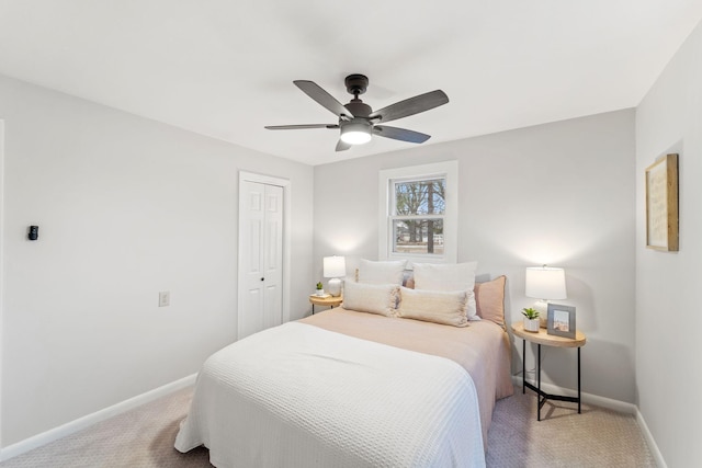 carpeted bedroom featuring ceiling fan and a closet