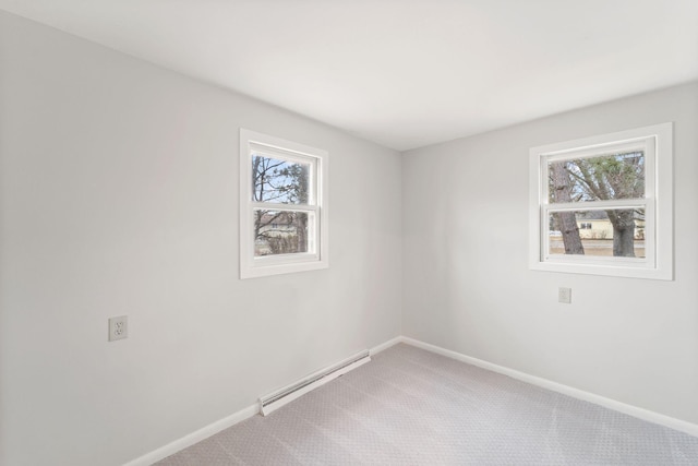 carpeted empty room with a baseboard radiator