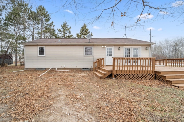 rear view of house featuring a wooden deck