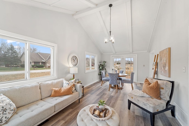 living area featuring baseboards, a chandelier, wood finished floors, beamed ceiling, and high vaulted ceiling