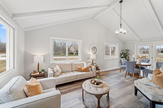 living area featuring vaulted ceiling with beams, baseboards, wood finished floors, and a notable chandelier