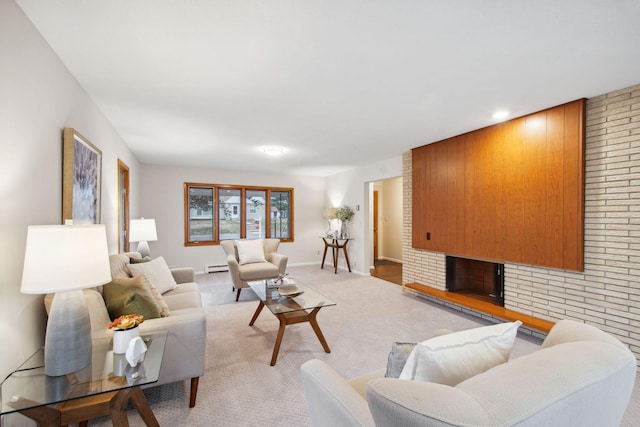 carpeted living room with a baseboard radiator and a brick fireplace