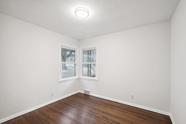 spare room featuring dark hardwood / wood-style flooring