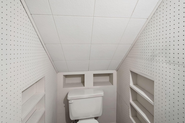 bathroom featuring lofted ceiling and toilet