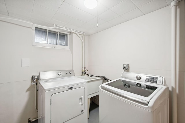 clothes washing area featuring independent washer and dryer