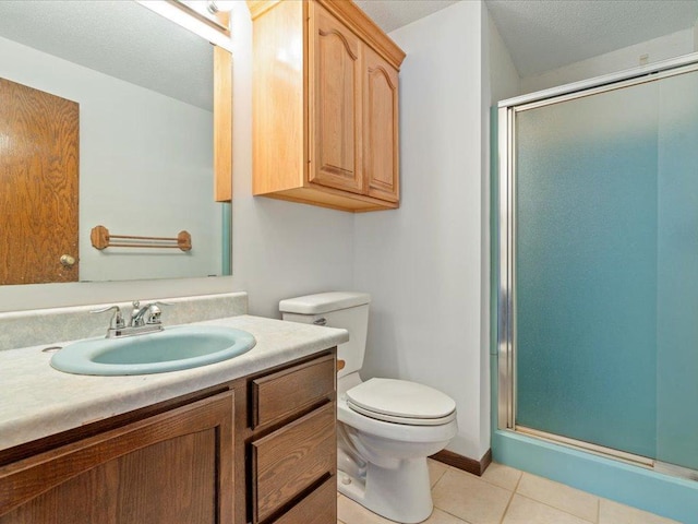 bathroom with tile patterned floors, toilet, a textured ceiling, vanity, and a shower with door