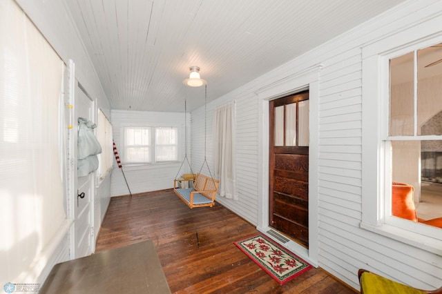 foyer with dark wood-type flooring and wooden ceiling