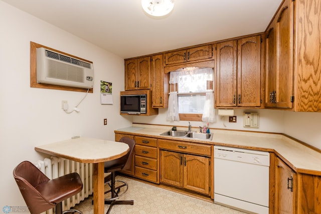 kitchen featuring sink, radiator heating unit, a wall unit AC, and dishwasher