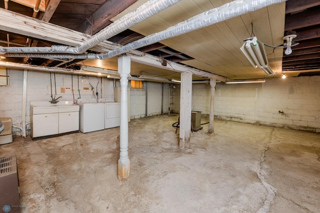 basement featuring sink and washing machine and dryer