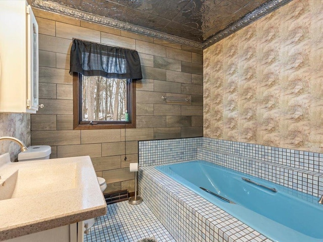 bathroom with a relaxing tiled tub, tile patterned floors, tile walls, and toilet