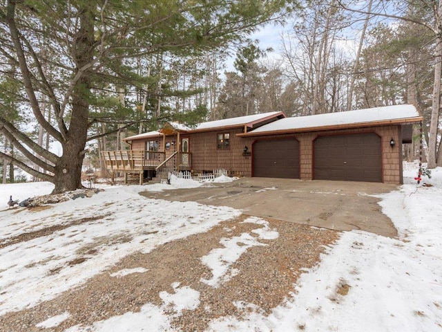 view of front facade with a garage and a wooden deck