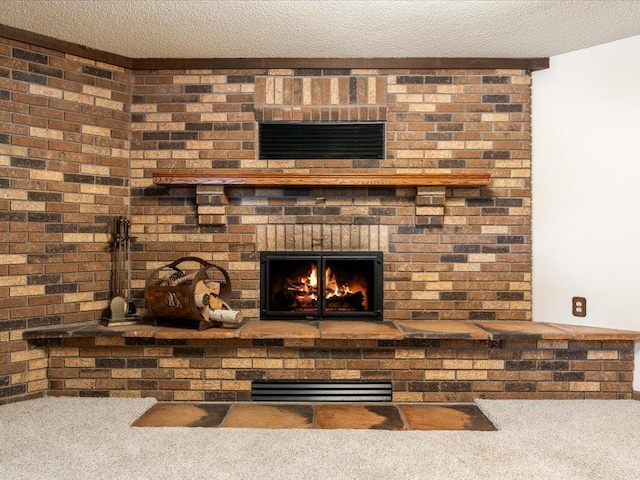 room details featuring a brick fireplace, carpet, and a textured ceiling