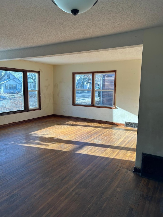 empty room featuring hardwood / wood-style flooring and a textured ceiling